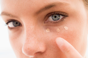 Woman applying concealer