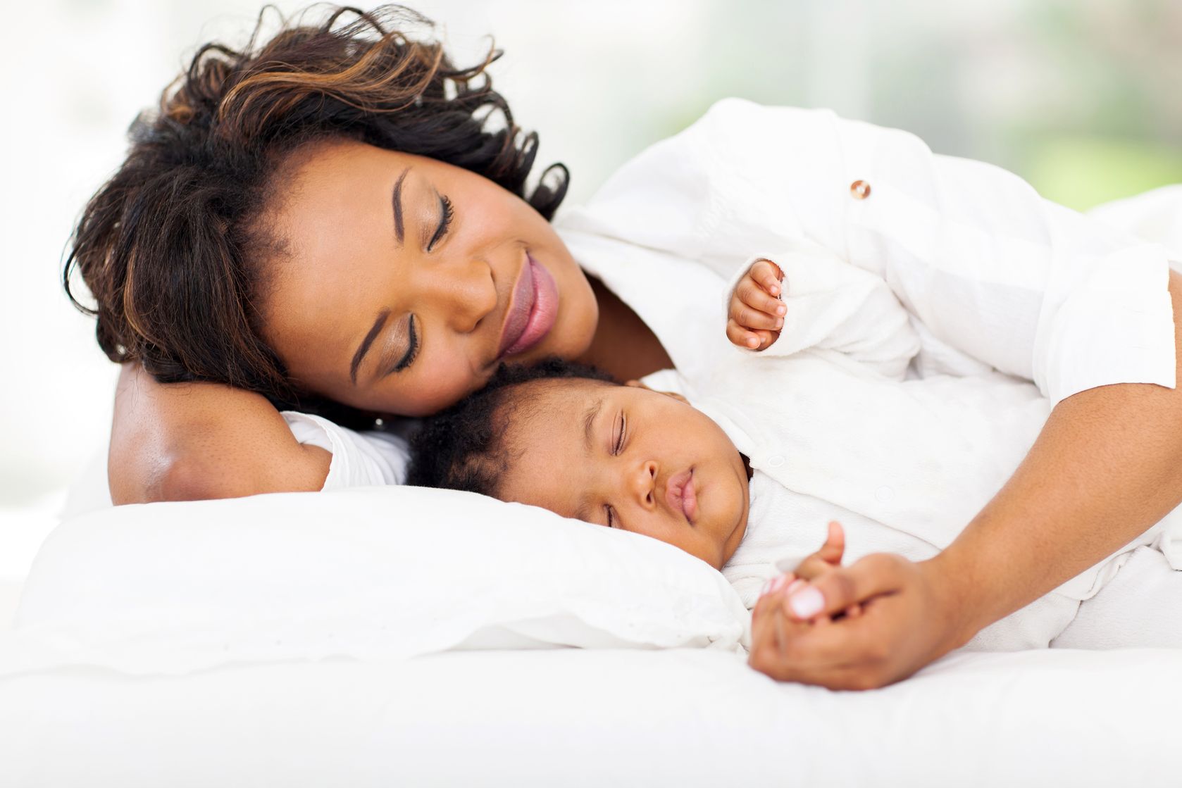 baby sleeping in middle of bed