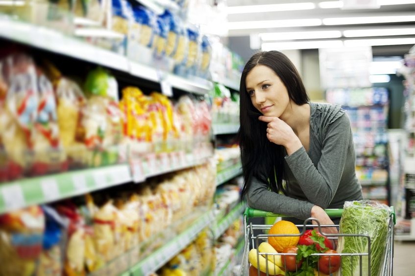 woman at grocery store looking at shelves