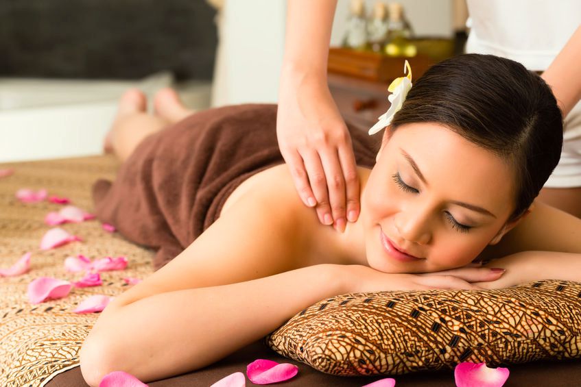 Asian woman in wellness beauty spa having aroma therapy massage with essential oil, looking relaxed