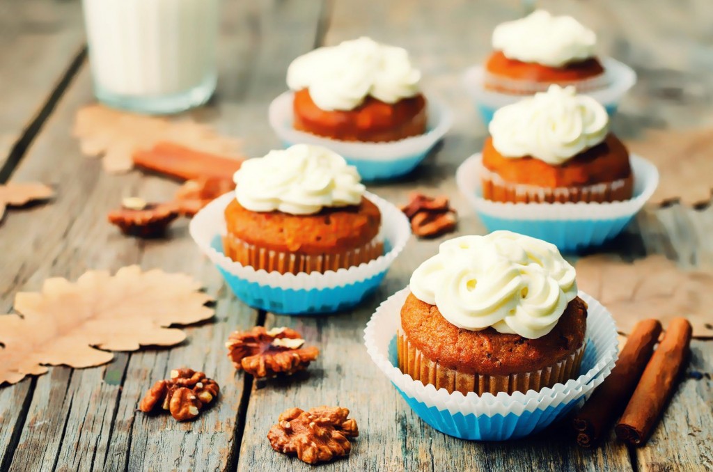 carrot cupcakes on a dark wood background