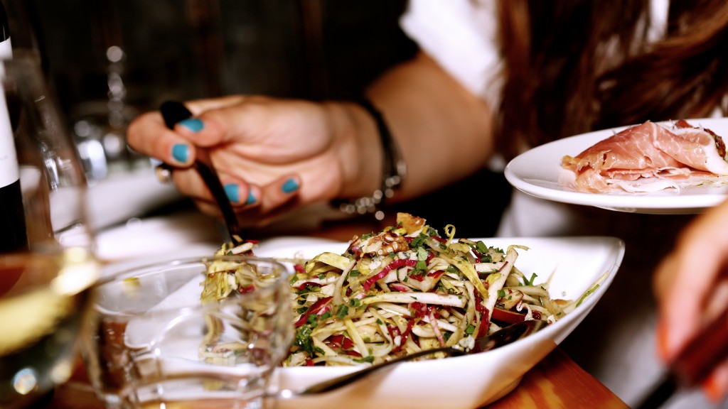 woman serving sald onto plate