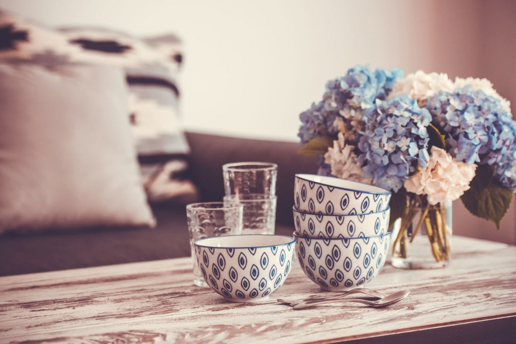 bowls and flowers on wooden table