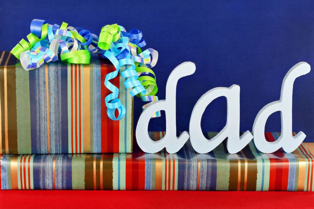 6827579 - masculine wrapped gifts with ribbons and the word dad on top.  ideal for dad's birthday or father's day.