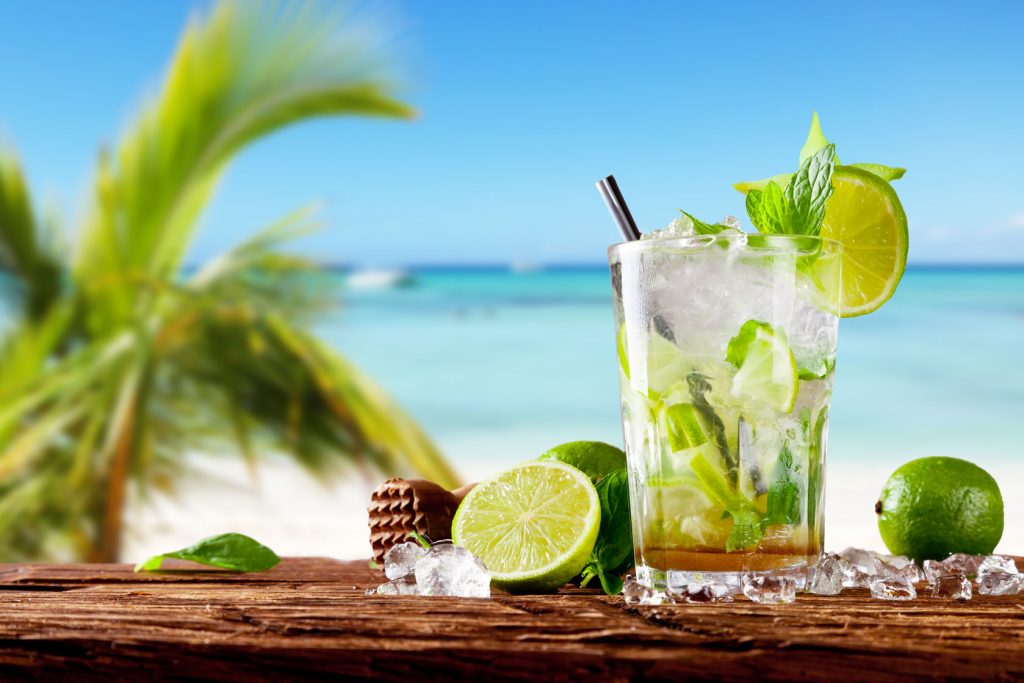 mojito drink against a beach backdrop